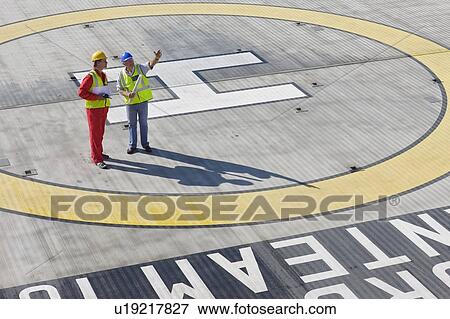 Workers standing on helideck View Large Photo Image Stock Photo - Workers standing on helideck. Fotosearch