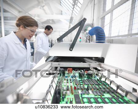 Workers with automated soldering machine View Large Photo Image Stock Image - Workers with automated soldering machine. Fotosearch