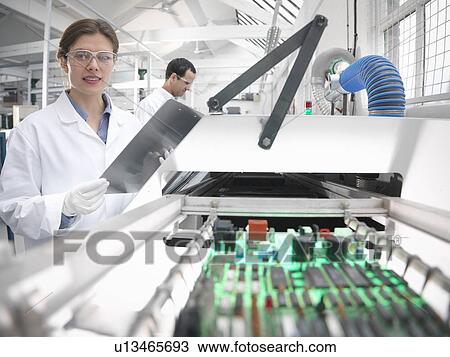 Workers with automated soldering machine View Large Photo Image Stock Image - Workers with automated soldering machine. Fotosearch