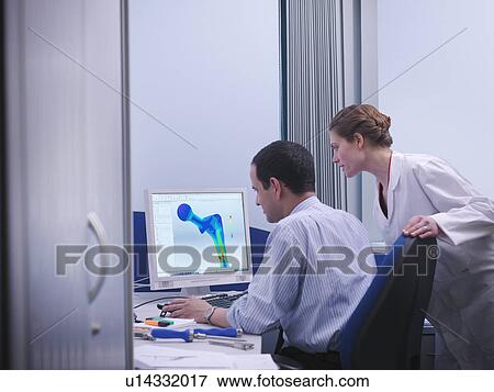 Workers with CAD drawing in office View Large Photo Image Stock Photo - Workers with CAD drawing in office. Fotosearch