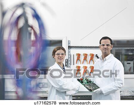 Stock Photo - Workers with electrical components. Fotosearch