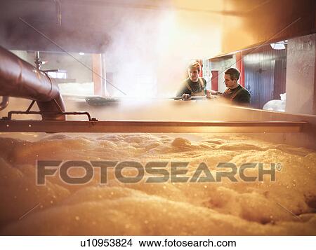 Workers with tank of hot wort in brewery View Large Photo Image Picture - Workers with tank of hot wort in brewery. Fotosearch