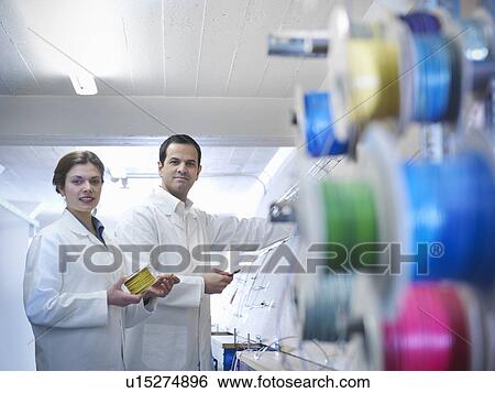 Stock Photograph - Workers with wiring loom. Fotosearch