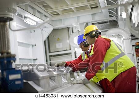 Stock Image - Working doing the maintenance of a ship. Fotosearch