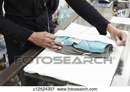 Stock Photo - Wrapping clothes. Fotosearch