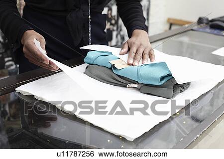 Wrapping clothes View Large Photo Image Stock Photograph - Wrapping clothes. Fotosearch