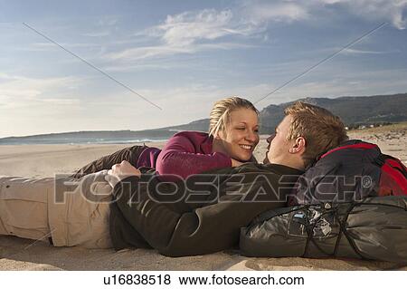Young backpackers lying on beach View Large Photo Image Stock Photo - Young backpackers lying on beach. Fotosearch