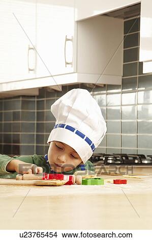 Picture - Young boy cooking in kitchen. Fotosearch