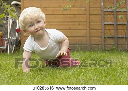 young boy crawling in garden View Large Photo Image Stock Photograph - young boy crawling in garden. Fotosearch