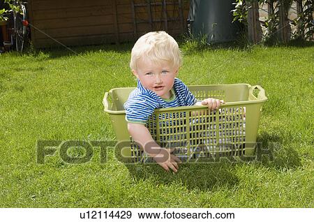 young boy sitting is washing basket View Large Photo Image Stock Photo - young boy sitting is washing basket. Fotosearch