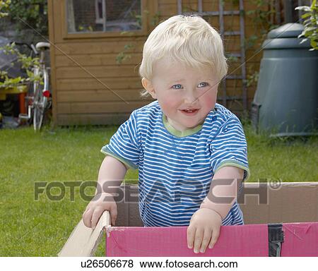 young boy standing in cardboard box View Large Photo Image Stock Photo - young boy standing in cardboard box. Fotosearch