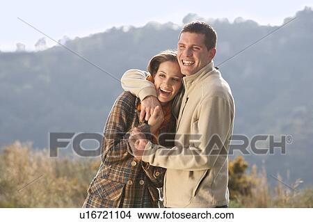 Picture - Young couple embracing in rural scene. Fotosearch