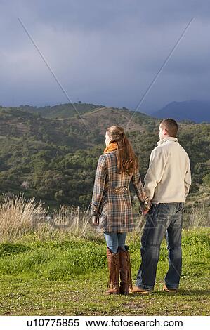 Young couple holding hands in nature View Large Photo Image Stock Photography - Young couple holding hands in nature. Fotosearch