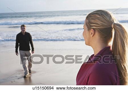Young couple meeting each other at beach View Large Photo Image Picture - Young couple meeting each other at beach. Fotosearch