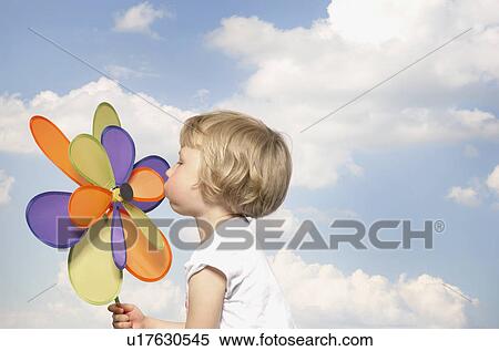 young girl blowing toy windmill View Large Photo Image Stock Photography - young girl blowing toy windmill. Fotosearch