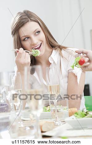 Young girl eating salad at lunch View Large Photo Image Stock Photography - Young girl eating salad at lunch. Fotosearch
