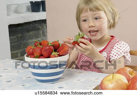 young girl eating strawberries View Large Photo Image Picture - young girl eating strawberries. Fotosearch