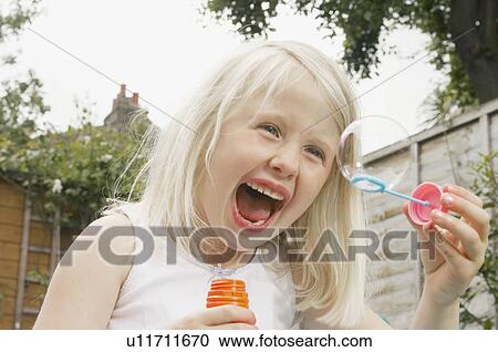 young girl having fun blowing bubbles View Large Photo Image Stock Image - young girl having fun blowing bubbles. Fotosearch