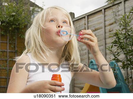 young girl having fun blowing bubbles View Large Photo Image Stock Image - young girl having fun blowing bubbles. Fotosearch