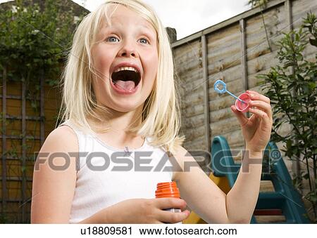 young girl having fun blowing bubbles View Large Photo Image Stock Image - young girl having fun blowing bubbles. Fotosearch