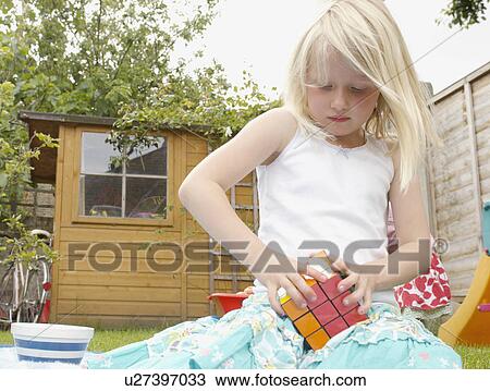 young girl playing with cube puzzle View Large Photo Image Stock Image - young girl playing with cube puzzle. Fotosearch