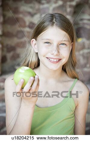Young girl with apple View Large Photo Image Stock Photography - Young girl with apple. Fotosearch