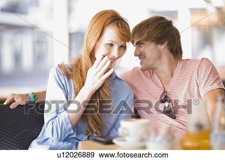 Stock Photo - Young laughing couple having some coffee . Fotosearch