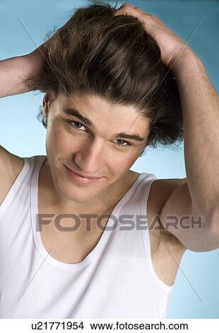 Young man hands to hair portrait View Large Photo Image Picture - Young man hands to hair portrait. Fotosearch
