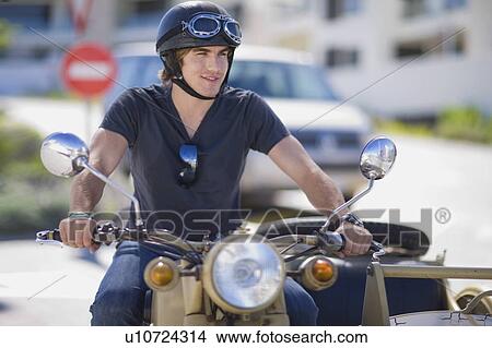 Young man riding a motorbike View Large Photo Image Picture - Young man riding a motorbike. Fotosearch
