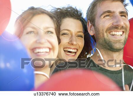 Young man & women with balloons View Large Photo Image Stock Image - Young man & women with balloons. Fotosearch