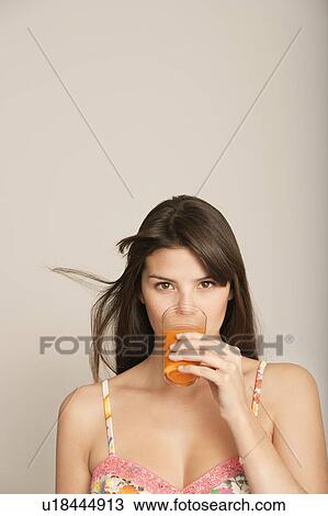 Stock Image - Young Woman drinking juice. Fotosearch