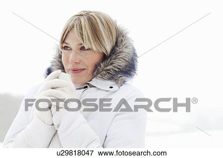 Young woman in fluffy hood in the snow View Large Photo Image Stock Photo - Young woman in fluffy hood in the snow. Fotosearch
