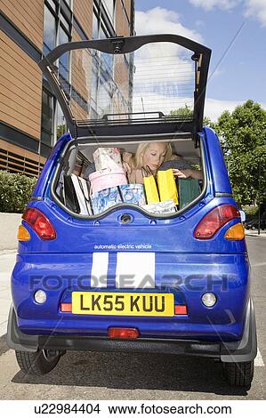 Young woman loading electric car View Large Photo Image Picture - Young woman loading electric car. Fotosearch
