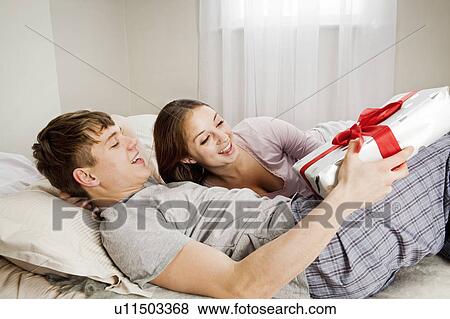 Young woman receives present View Large Photo Image Stock Photo - Young woman receives present. Fotosearch