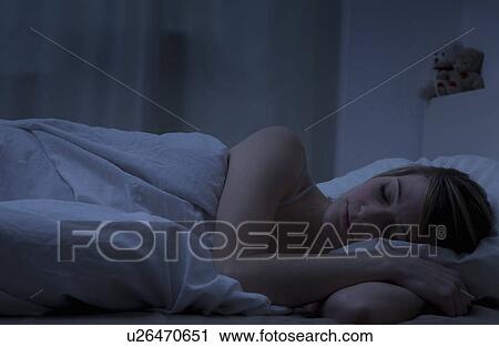 Stock Image - Young woman sleeping. Fotosearch