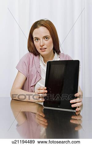 Young woman using new technology View Large Photo Image Stock Photo - Young woman using new technology. Fotosearch
