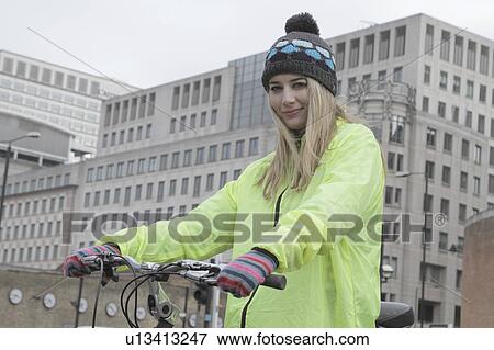 Young woman with bicycle in the city View Large Photo Image Stock Photo - Young woman with bicycle in the city. Fotosearch