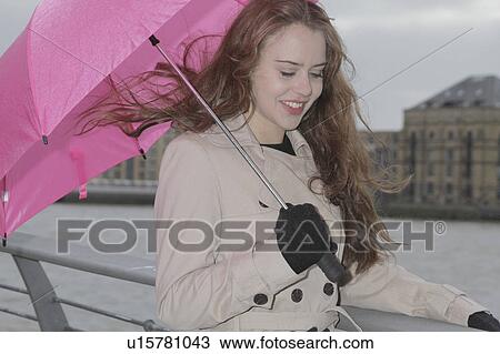 Young woman with pink umbrella View Large Photo Image Stock Image - Young woman with pink umbrella. Fotosearch