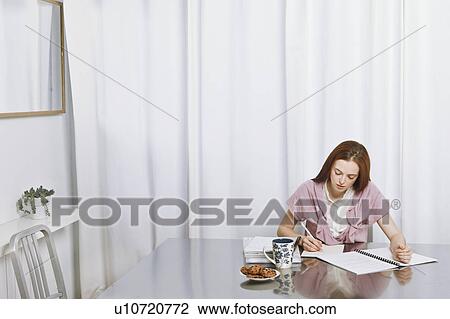 Young woman working at home View Large Photo Image Stock Image - Young woman working at home. Fotosearch