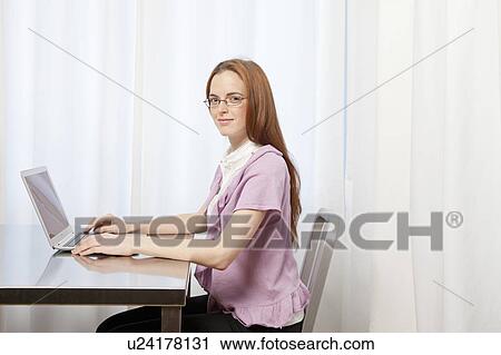 Young woman working at home View Large Photo Image Stock Image - Young woman working at home. Fotosearch