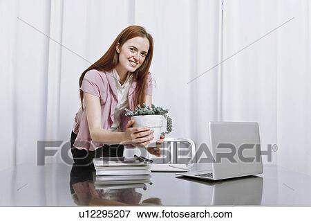Young woman working at home View Large Photo Image Stock Photo - Young woman working at home. Fotosearch
