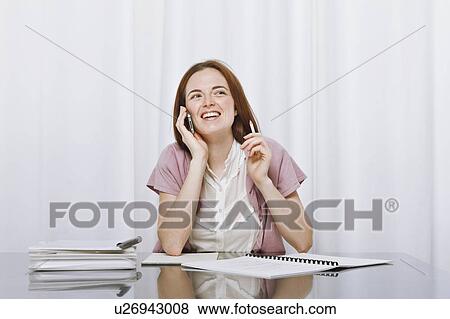 Stock Photo - Young womanworking at home. Fotosearch