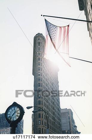 Picture - American flag hanging over city street . Fotosearch
