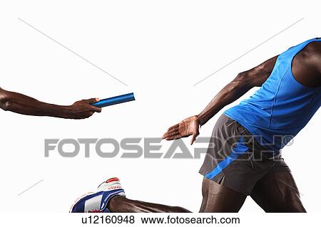 Stock Photo - Athlete passing relay baton. Fotosearch