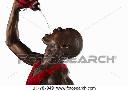 Athlete pouring water into his mouth View Large Photo Image Stock Photo - Athlete pouring water into his mouth. Fotosearch