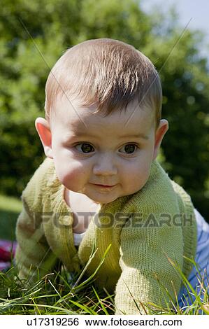 Stock Photograph - Baby boy crawling in grass. Fotosearch