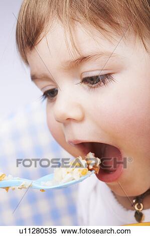 Baby girl being spoon-fed View Large Photo Image Stock Photography - Baby girl being spoon-fed. Fotosearch