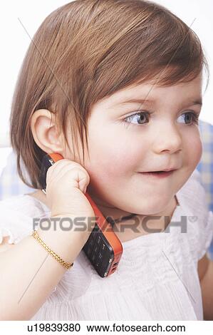 Baby girl playing with cell phone View Large Photo Image Stock Image - Baby girl playing with cell phone. Fotosearch
