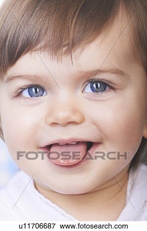 Baby girl sticking out her tongue View Large Photo Image Stock Photo - Baby girl sticking out her tongue. Fotosearch