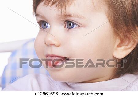 Baby girl sticking out her tongue View Large Photo Image Stock Photograph - Baby girl sticking out her tongue. Fotosearch